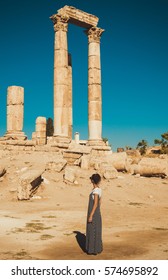 Photo of the Female tourist in long sundress visit and exploring historic attraction. Woman enjoy summer vacation. Sightseeing tour. Tourism industry. Travel lifestyle. Active rest concept - Shutterstock ID 574695892