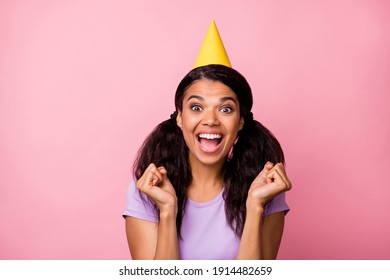 Photo of festive young dark skin woman wear cone hat raise fists birthday isolated o pastel pink color background - Powered by Shutterstock