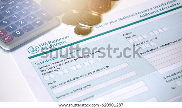 Photo of filling in a\
HM customs form a personal details for UK self assessment tax and\
benefits right.