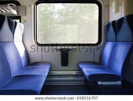 photo of Five blue seats facing each other in modern European train
