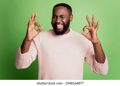 Photo Of Flirty Adviser American Man Show Two Ok Signs Wink Eye Wear White Shirt Over Green Background