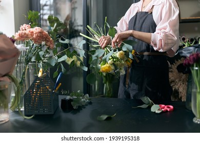 Photo of florist holding beautiful flowers in flower shop, copy space. Lifestyle flower shop. Beautiful flower composition. - Powered by Shutterstock