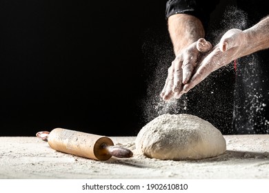 Photo of flour and men hands with flour splash. Cooking bread. Kneading the Dough. Isolated on dark background. Empty space for text. - Powered by Shutterstock