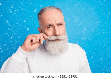 Photo of focused aged man arm touching moustache look camera wear sweater isolated on blue color background - Powered by Shutterstock