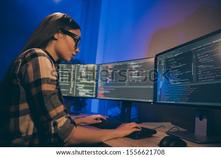 Photo of focused concentrated serious programmer looking through code of artificial intelligence to be debugged