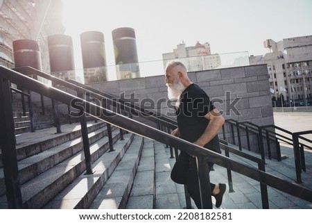 Photo of focused concentrated sportive man run rush stairs endurance warm-up wear t-shirt urban town outdoors