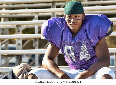 Photo Of Football Player Watching From Bleachers