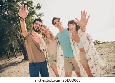 Photo Of Four Friendly Buddies Make Remote Zoom Video Call Wave Hand Wear Casual Outfit Nature Seaside Beach Outside