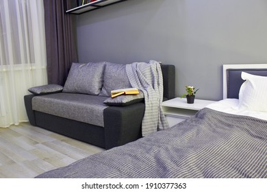 In The Photo, A Fragment Of A Beautiful Modern Bedroom In A Room With A Bed, Sofa And Other Furniture.