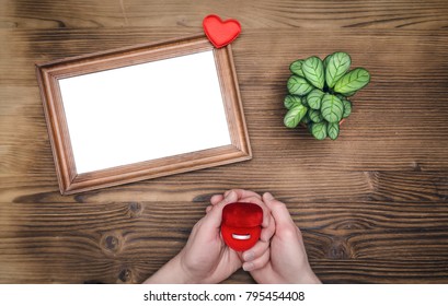 Photo Frame With Copy Space In Male Hands And Wedding Ring In A Present Box. Declaration Of Love. Offer To Get Married. Miss Of Girl Friend.