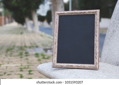 Photo Frame On A Park Bench. Mock Up.