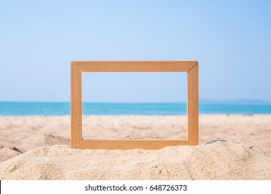 Photo Frame On Sand Beach