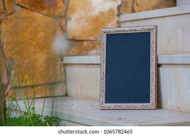 Photo Frame On A Stone Staircase. Black Billboard. Mock Up.