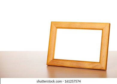 Photo Frame On Wood Table. Isolated On White Background