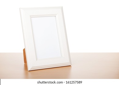 Photo Frame On Wood Table. Isolated On White Background