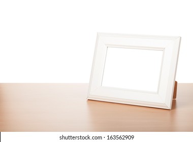 Photo Frame On Wood Table. Isolated On White Background