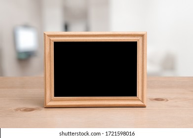 Photo Frame On The Wooden Table In The Living Room