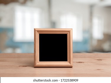 Photo Frame On The Wooden Table In The Living Room