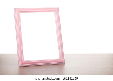 Photo Frame On Wooden Table. Isolated On White Background