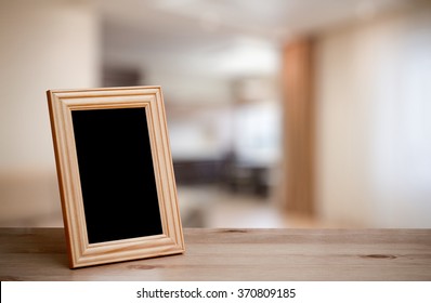 Photo Frame On The Wooden Table In The Living Room