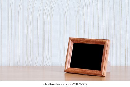 Photo Frame On Wooden Table