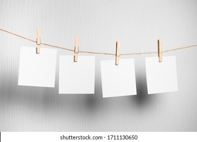 Photo frame.Retro photo frames hanging on rope isolated on white background. real photo. four frames - Powered by Shutterstock