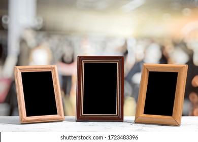 Photo Frames On The Wooden Table In The Living Room