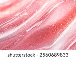 Photo of Fresh lip gloss smear of bright pink color close up. Background texture for backdrops or mapping