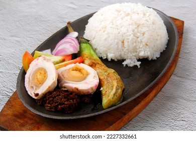 Photo of freshly cooked called Ensaladang Talong with rice or egg plant salad served with shrimp paste, salted egg and rice.