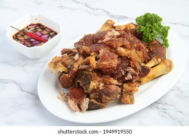 Photo of freshly cooked Filipino food called Crispy Pata or deep fried crispy pork leg.
