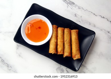 Photo Of Freshly Cooked Filipino Food Called Lumpiang Shanghai Or Fried Ground Pork Meat In Spring Roll Wrapper.