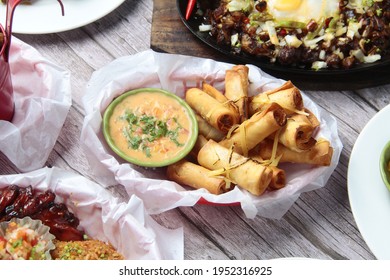 Photo Of Freshly Cooked Filipino Food Called Lumpiang Shanghai Or Fried Ground Pork Meat In Spring Roll Wrapper.