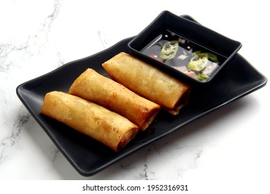 Photo Of Freshly Cooked Filipino Food Called Lumpiang Shanghai Or Fried Ground Pork Meat In Spring Roll Wrapper.