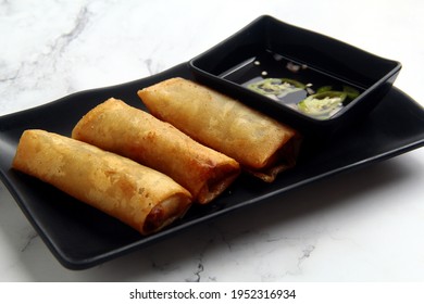 Photo Of Freshly Cooked Filipino Food Called Lumpiang Shanghai Or Fried Ground Pork Meat In Spring Roll Wrapper.