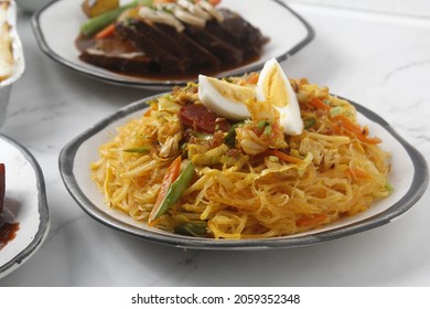 Photo of freshly cooked Filipino food called Bam-i Pancit or stir fried thin noodles with mixed meat and vegetables.