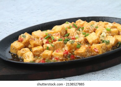 Photo of freshly cooked Filipino food called Sizzling Tokwa Sisig or chopped tofu served in a hot plate.