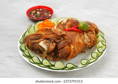 Photo of freshly cooked Filipino food called Crispy Pata or deep fried pork leg.