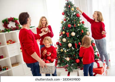 Photo Of Full Big Family Five People Gathering Three Small Kids Decorate X-mas Tree Dad Hold Box Give Ball Mom Son Wear Red Jumper Jeans In Home Living Room Presents Mistletoe Indoors