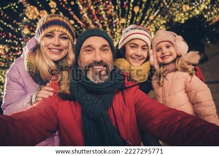 Photo of full idyllic family take selfie spend midnight fair market garland street outdoors