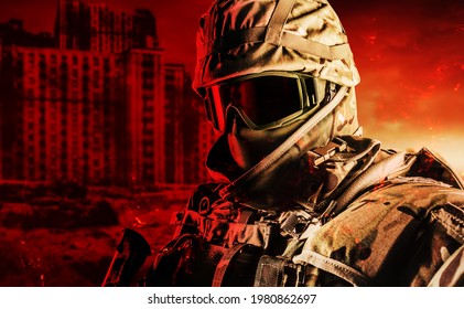 Photo of fully equipped soldier in heavy level 3 armor ammunition standing on red destructed city battlefield background.