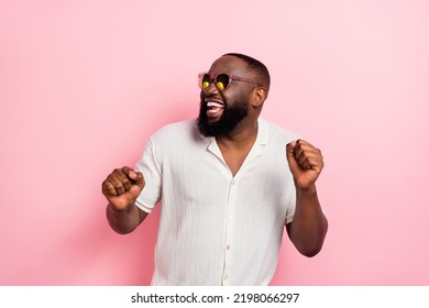 Photo of funky attarctive guy dressed white shirt dark glasses smiling having fun isolated pink color background
