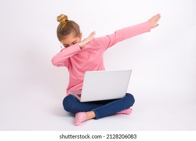 Photo Of Funky Beautiful Caucasian Teen Girl Sitting With Laptop In Lotus Position On White Background Show Disco Move Dab