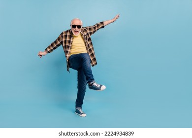 Photo of funky cook retired man wear plaid shirt dark glasses dancing empty space isolated blue color background