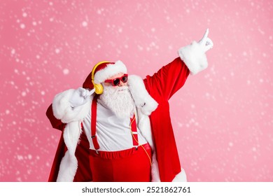 Photo funky cool santa claus have x-mas christmas party event celebration listen headphones music raise fingers dance wear sunglass suspenders cap headwear isolated pastel color background - Powered by Shutterstock