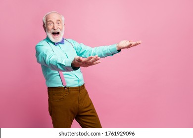 Photo Of Funky Crazy Amazed Grandpa Hold Hands Raised Up Catch Throw Air Falling Novelty Low Price Product Wear Specs Mint Shirt Suspenders Bow Tie Pants Isolated Pink Pastel Color Background