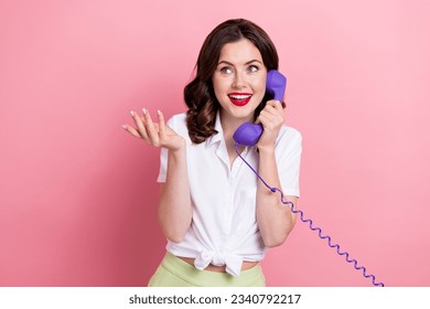 Photo of funky dreamy young lady wear white shirt speaking retro telephone looking empty space isolated pink color background - Powered by Shutterstock