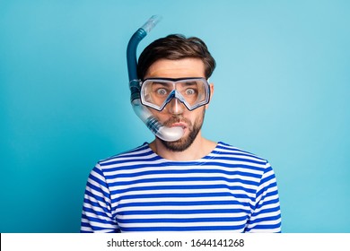 Photo of funky emotional handsome guy tourist diving underwater mask see colorful fish corals breathing tube floating deep wear striped sailor shirt isolated blue color background