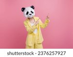 Photo of funky funny lady wear yellow jacket suit bear mask pointing two fingers empty space isolated pink color background