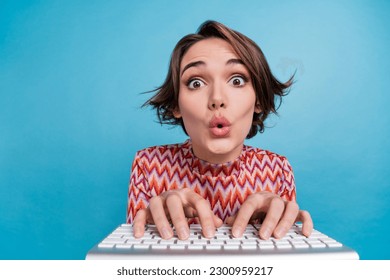 Photo of funky impressed lady wear striped top chatting keyboard big eyes isolated blue color background