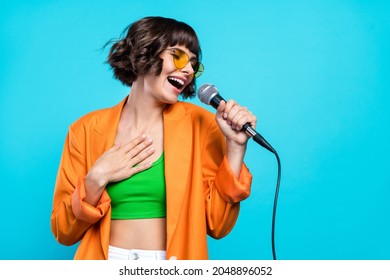 Photo of funky millennial brunette lady sing wear cardigan top isolated on teal color background